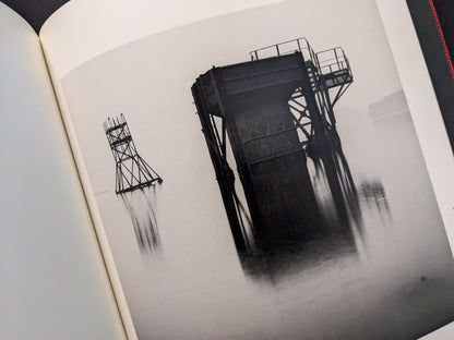 Abstract image of a collapsing coal tower reflected on water, from Berg Werk by Sincei Yamamoto