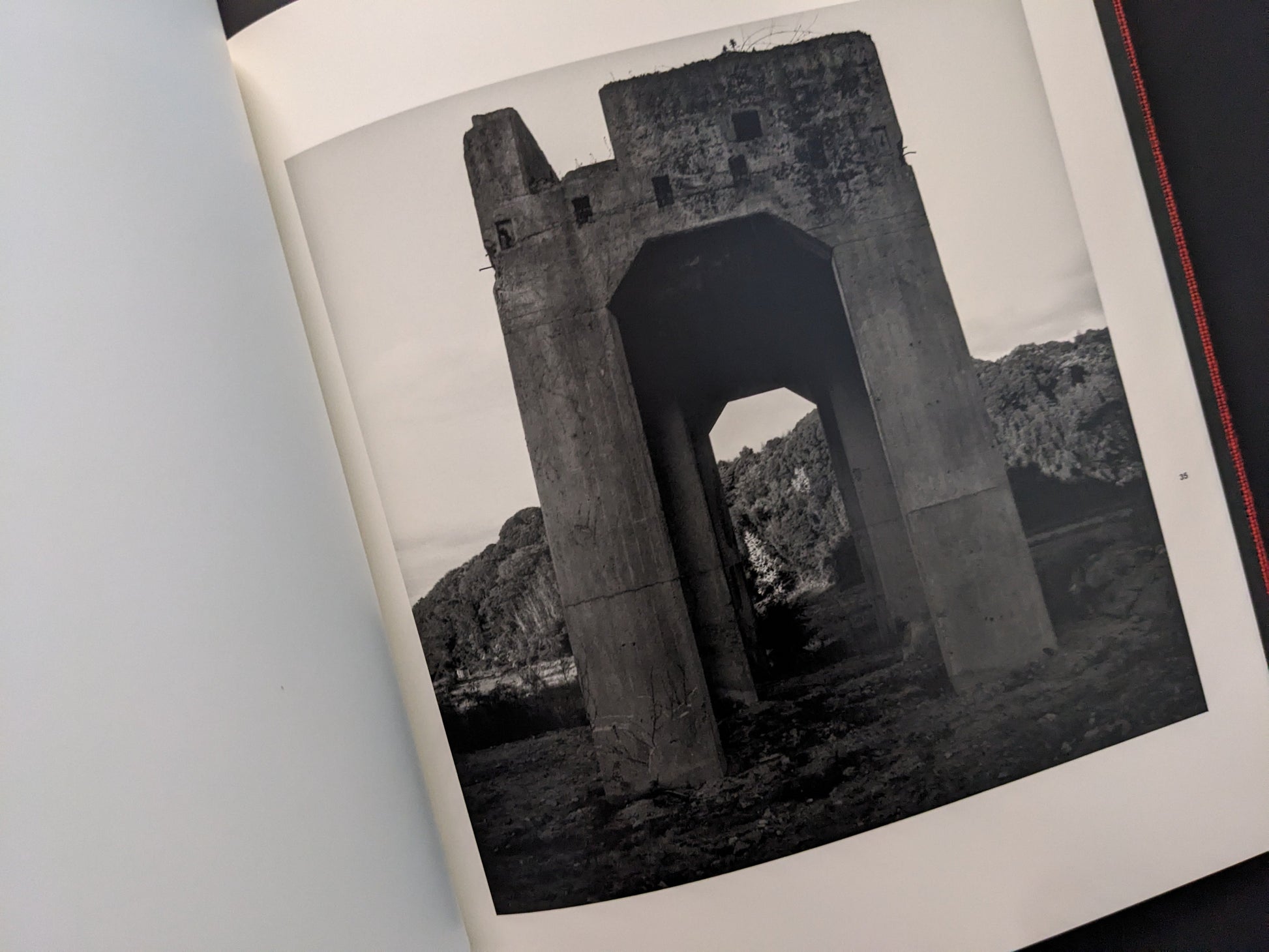 Large concrete mining structure in a desolate landscape, from Berg Werk by Sincei Yamamoto
