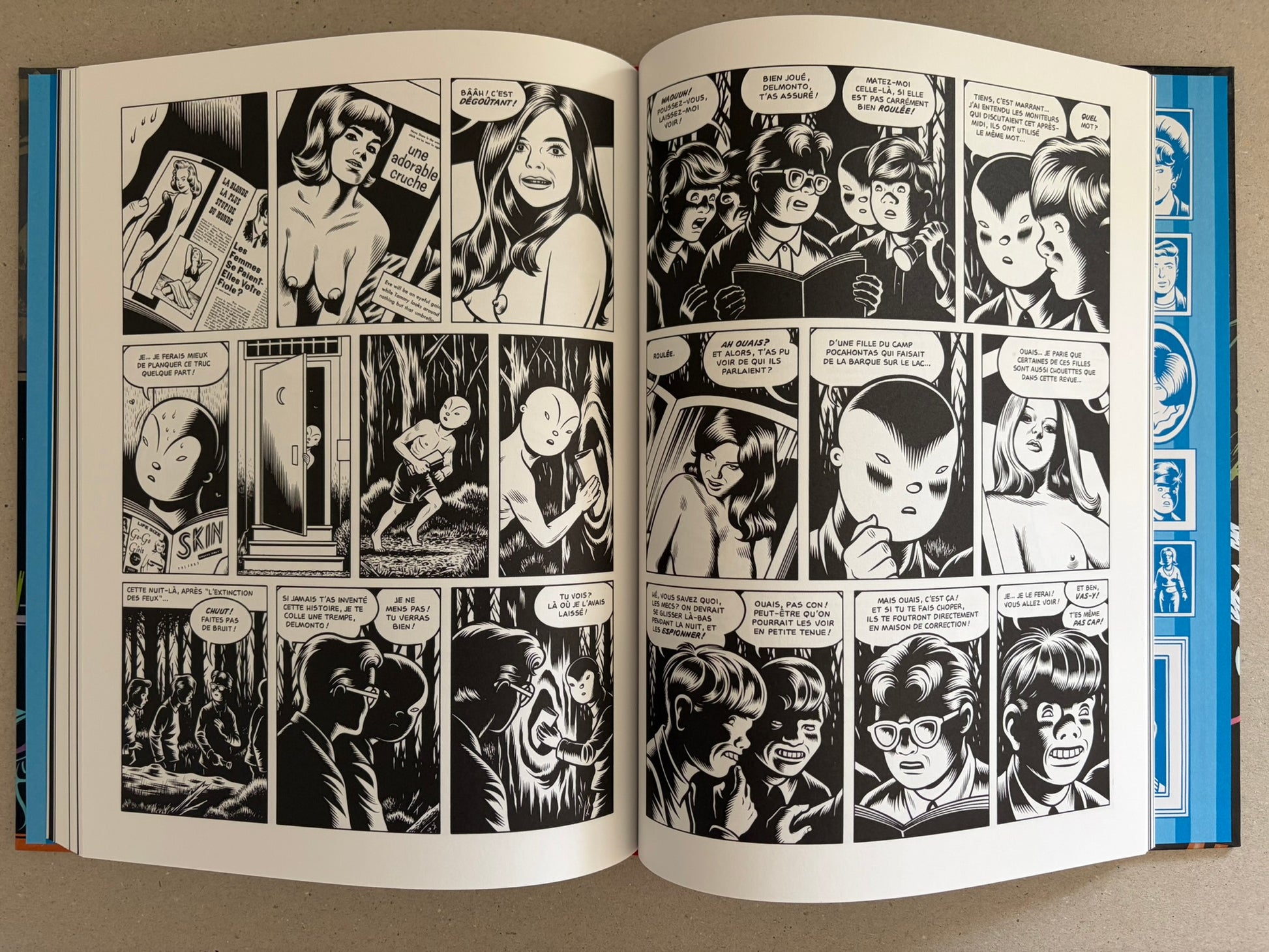 Open spread from Big Baby with black-and-white comic panels and illustrated character portraits along the page edge.