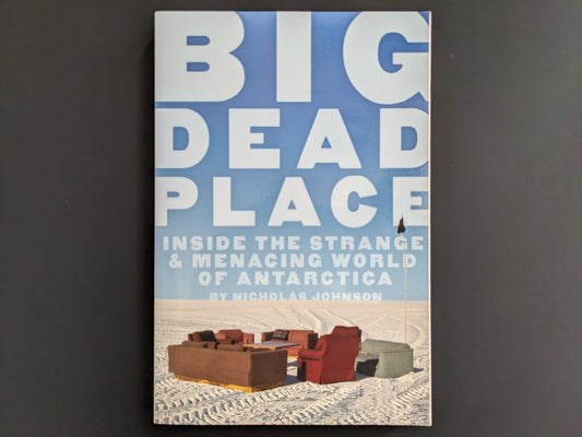 Front cover of "Big Dead Place" by Nicholas Johnson, showing sofas on Antarctic ice under a clear blue sky