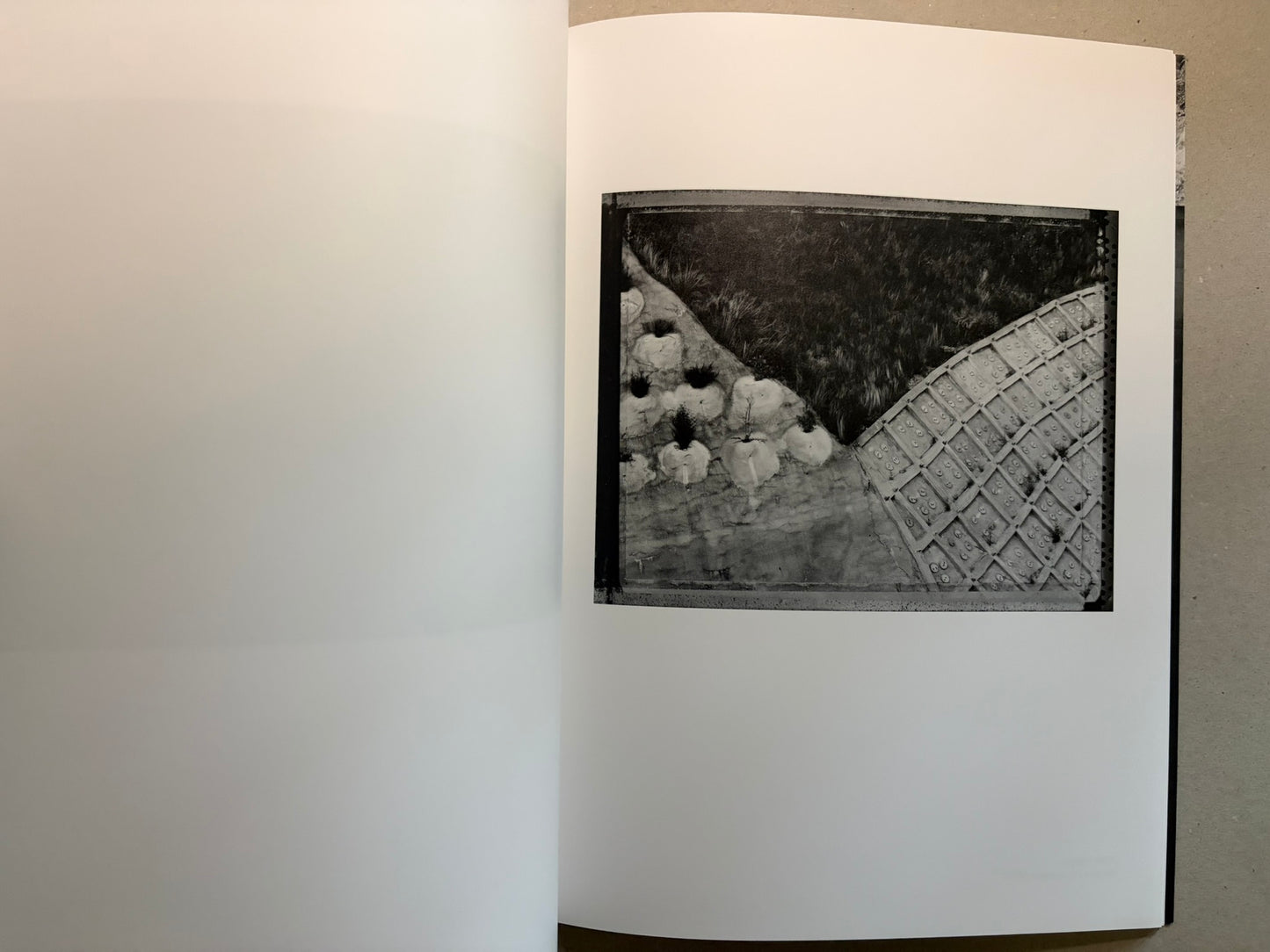 Boundary Hunt by Toshio Shibata, open spread with a black-and-white photograph of a mountain and road on the right page.