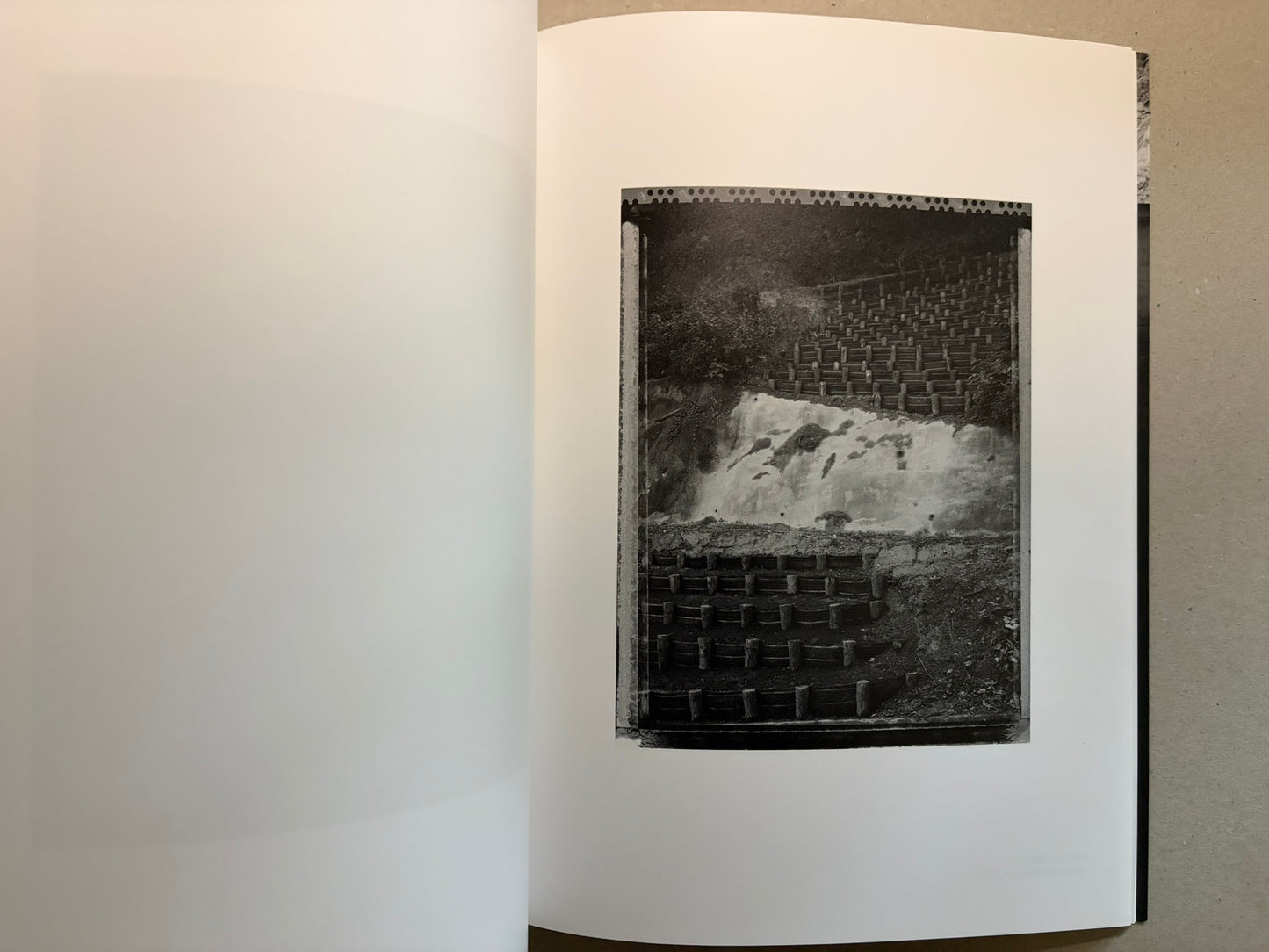 Boundary Hunt by Toshio Shibata, open spread with a black-and-white photograph of a vertical textured surface on the right page.