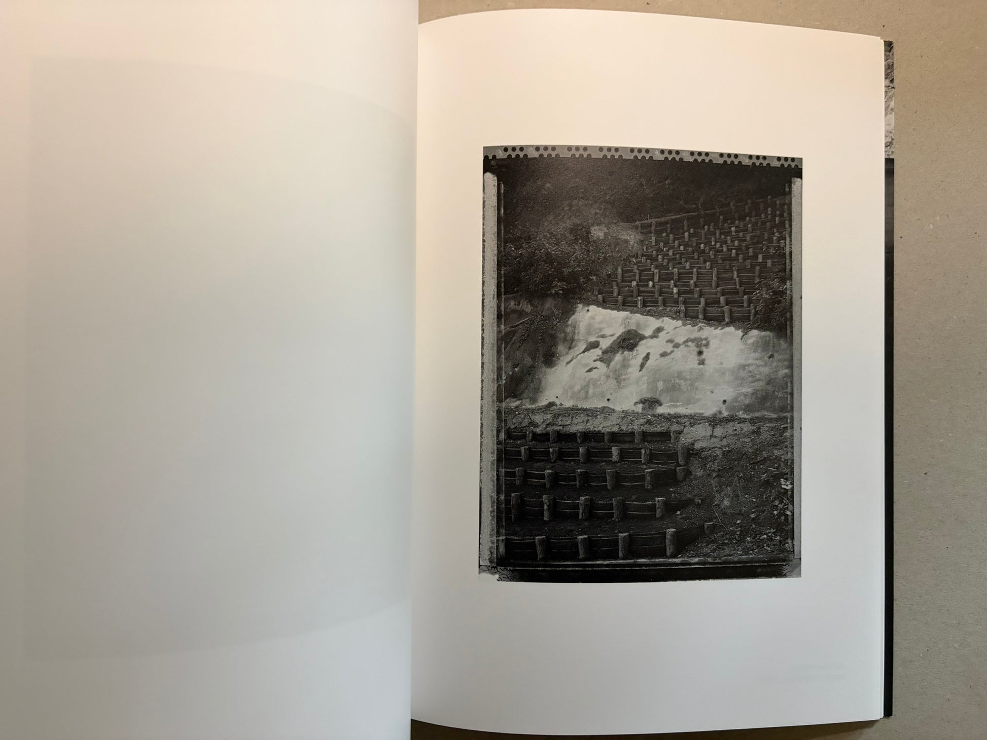 Boundary Hunt by Toshio Shibata, open spread with a black-and-white photograph of a vertical textured surface on the right page.