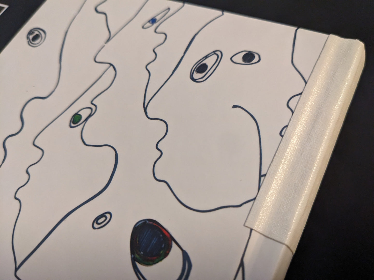 Detail of the book spine repaired with white cloth tape.