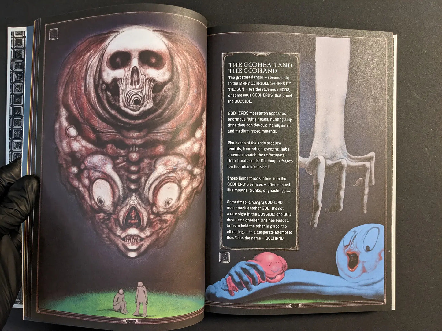 Spread from Bubzium featuring a multi-eyed skull godhead, a pale reaching hand and a blue figure clutching a pink limb.