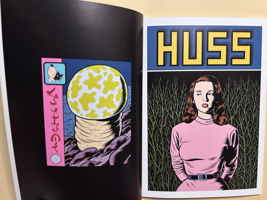 Interior spread from Caprice by Charles Burns showing two fictional comic covers, one titled HUSS and one with a pink-haired woman.