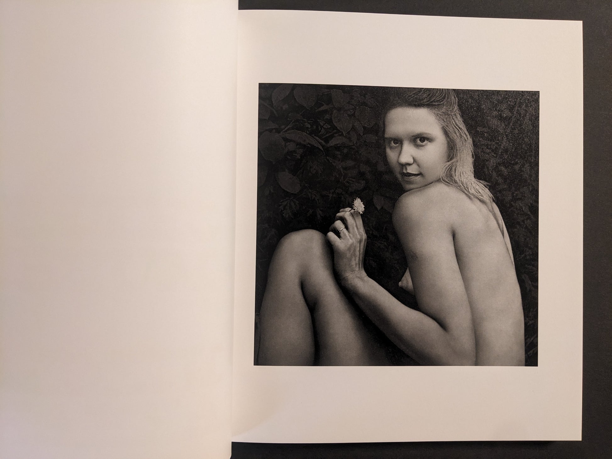 Interior photo from Cheryomushki by Nikolay Bakharev: black-and-white portrait of a woman outdoors holding a small flower.