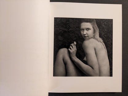 Interior photo from Cheryomushki by Nikolay Bakharev: black-and-white portrait of a woman outdoors holding a small flower.