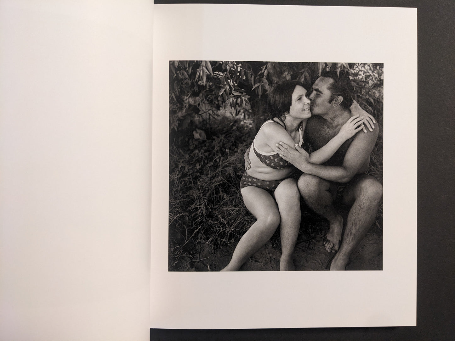 Interior photo from Cheryomushki: black-and-white portrait of a couple embracing in swimwear by the water.