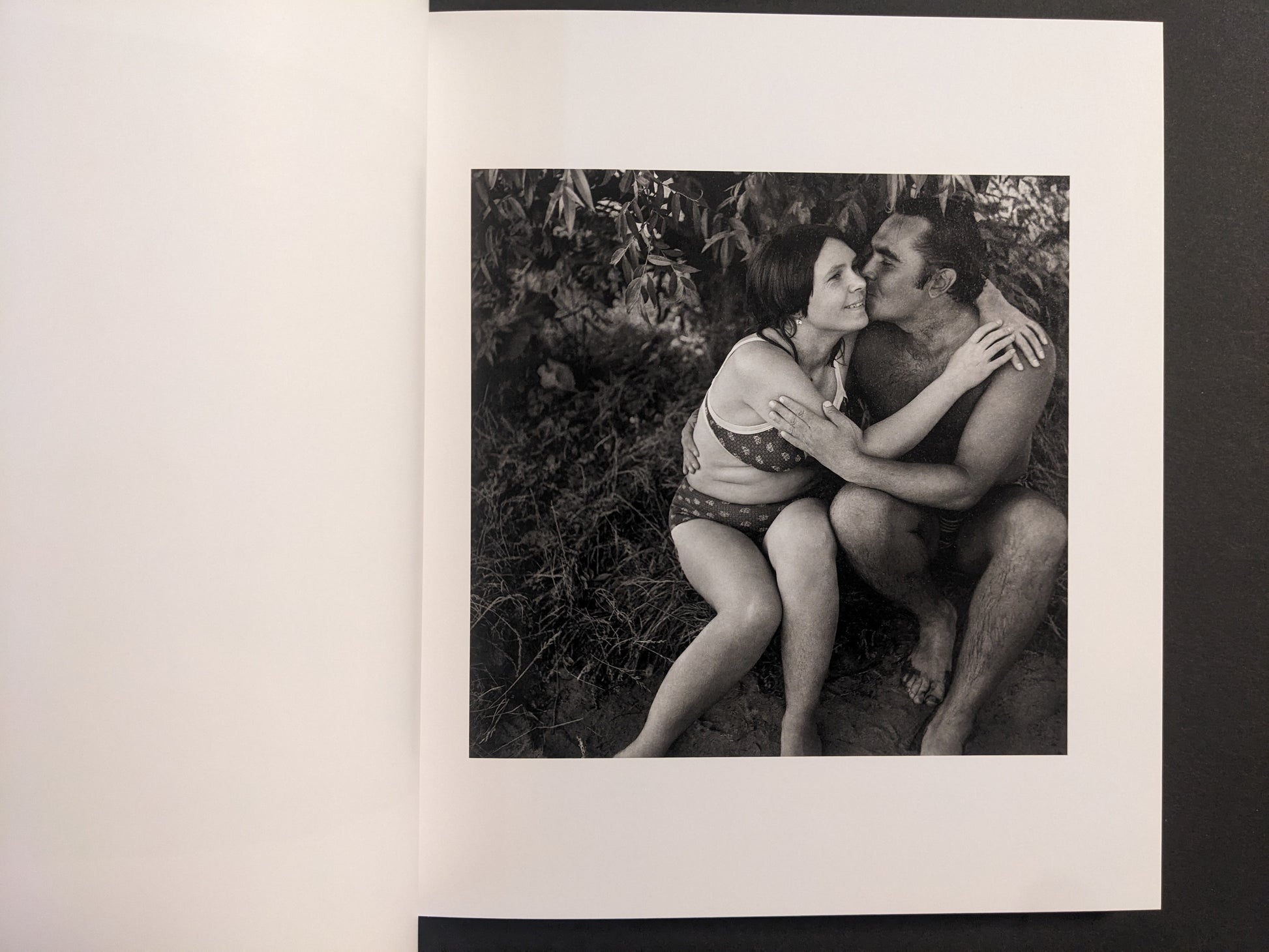 Interior photo from Cheryomushki: black-and-white portrait of a couple embracing in swimwear by the water.