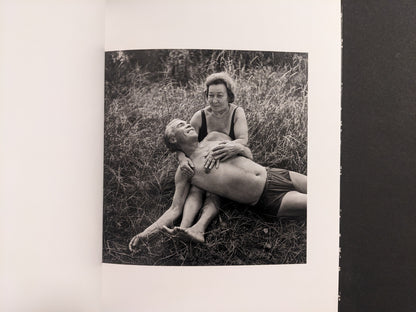 Interior photo from Cheryomushki: black-and-white portrait of an older couple resting in grass, posed affectionately.