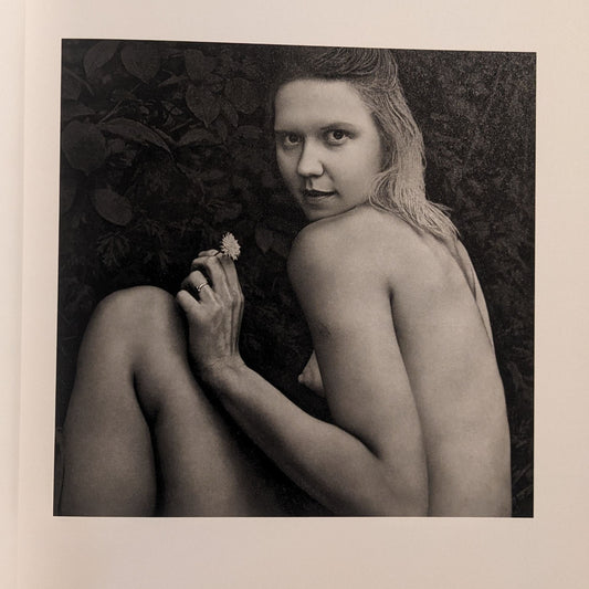 Interior photo from Cheryomushki by Nikolay Bakharev: black-and-white portrait of a woman outdoors holding a small flower.