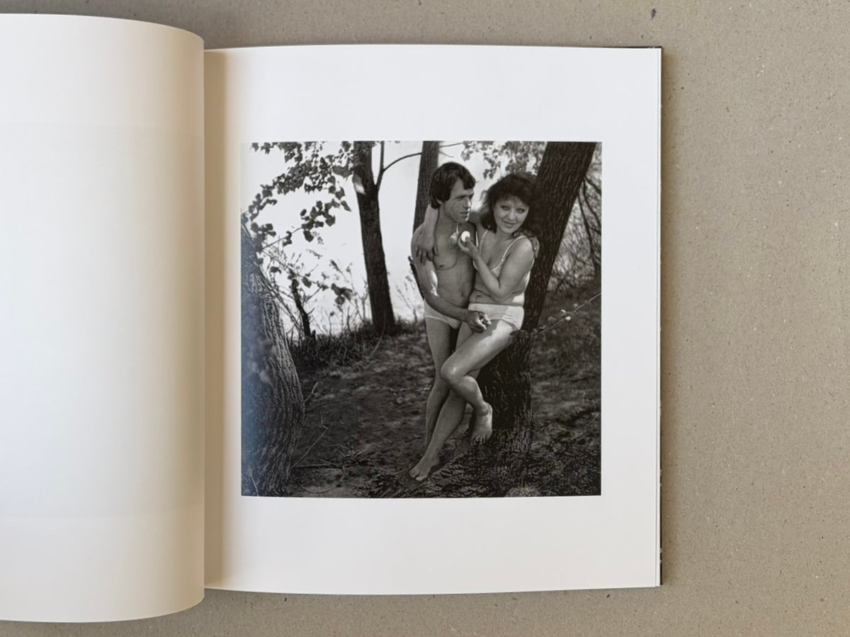 Open spread of Cheryomushki — Nikolay Bakharev showing a black-and-white photograph of a couple standing by a tree.