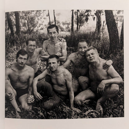 Cheryomushki by Nikolay Bakharev interior photo: black-and-white group portrait of six men resting in the woods, one holding a bottle.