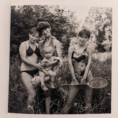 Cheryomushki by Nikolay Bakharev interior photo: black-and-white portrait of three girls with a toddler outdoors, one holding a badminton racket.