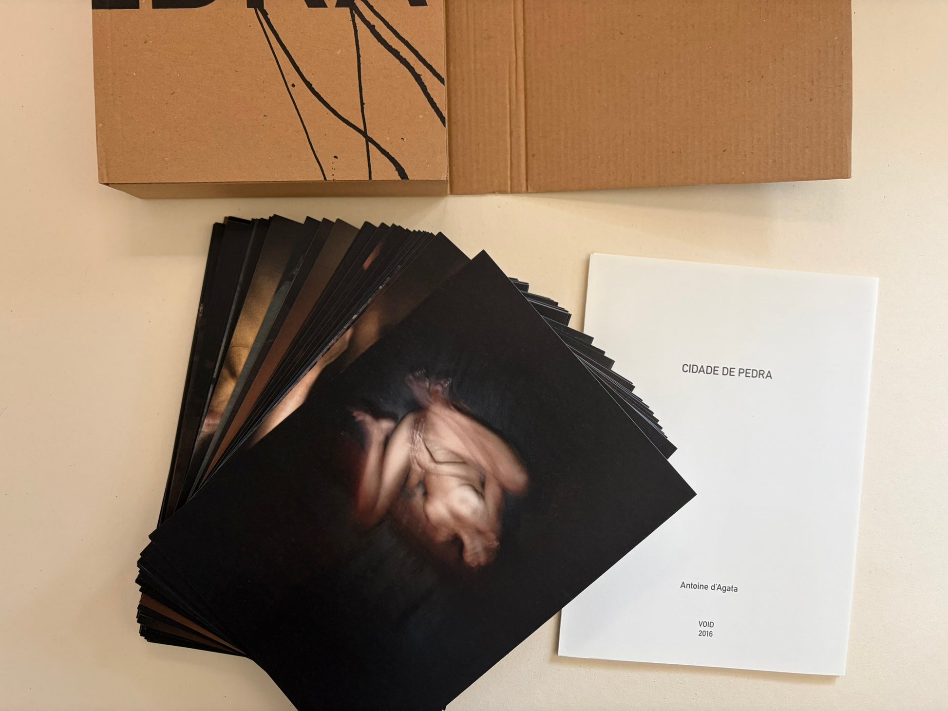 Cidade de Pedra by Antoine d'Agata, folded pages and loose insert spread out from the case.