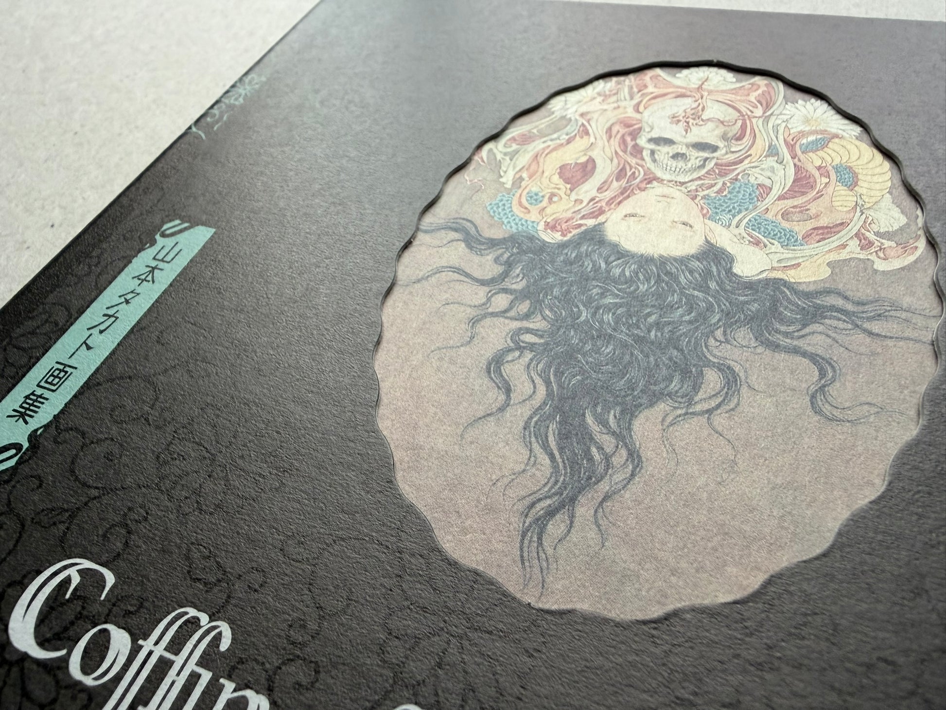 Close-up of the Coffin of a Chimera sleeve case artwork, showing the central chimera motif and title detail.