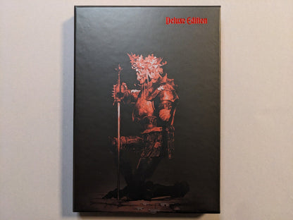 Collector slipcase for Cursed Swords with red armored-knight artwork and “Deluxe Edition” marking; hot-stamped metallic detail.