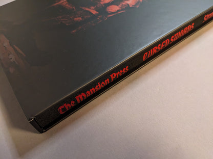 Collector slipcase spine for Cursed Swords — Deluxe Slipcase Edition showing the red foiled title and publisher mark.