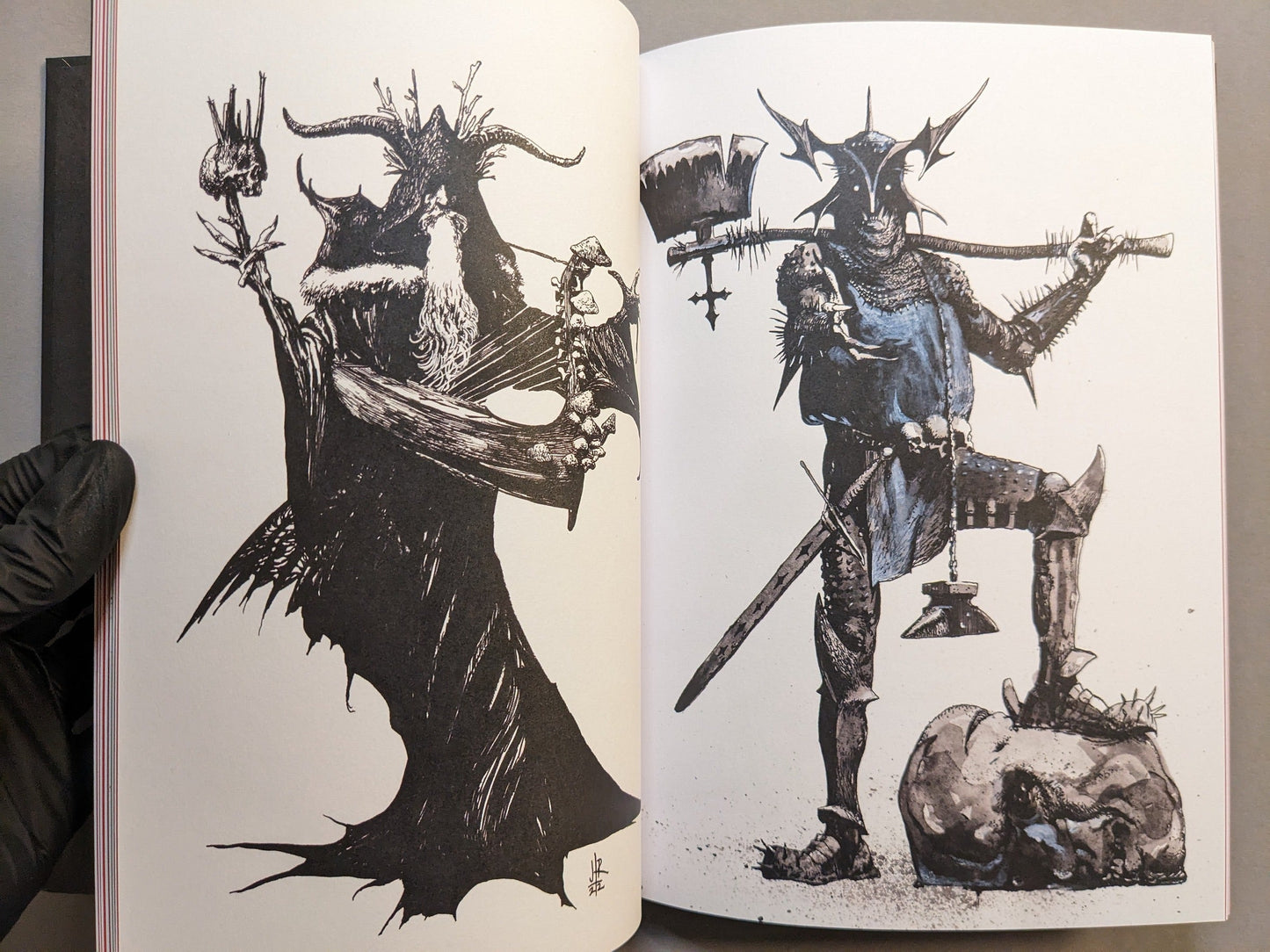 Interior spread with two dark-fantasy character illustrations in spiked armor wielding axes; detailed black-ink work.
