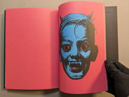 Interior spread from Cursed Swords: skeletal jester with spiral winglets opposite a horned, snarling portrait in ink.