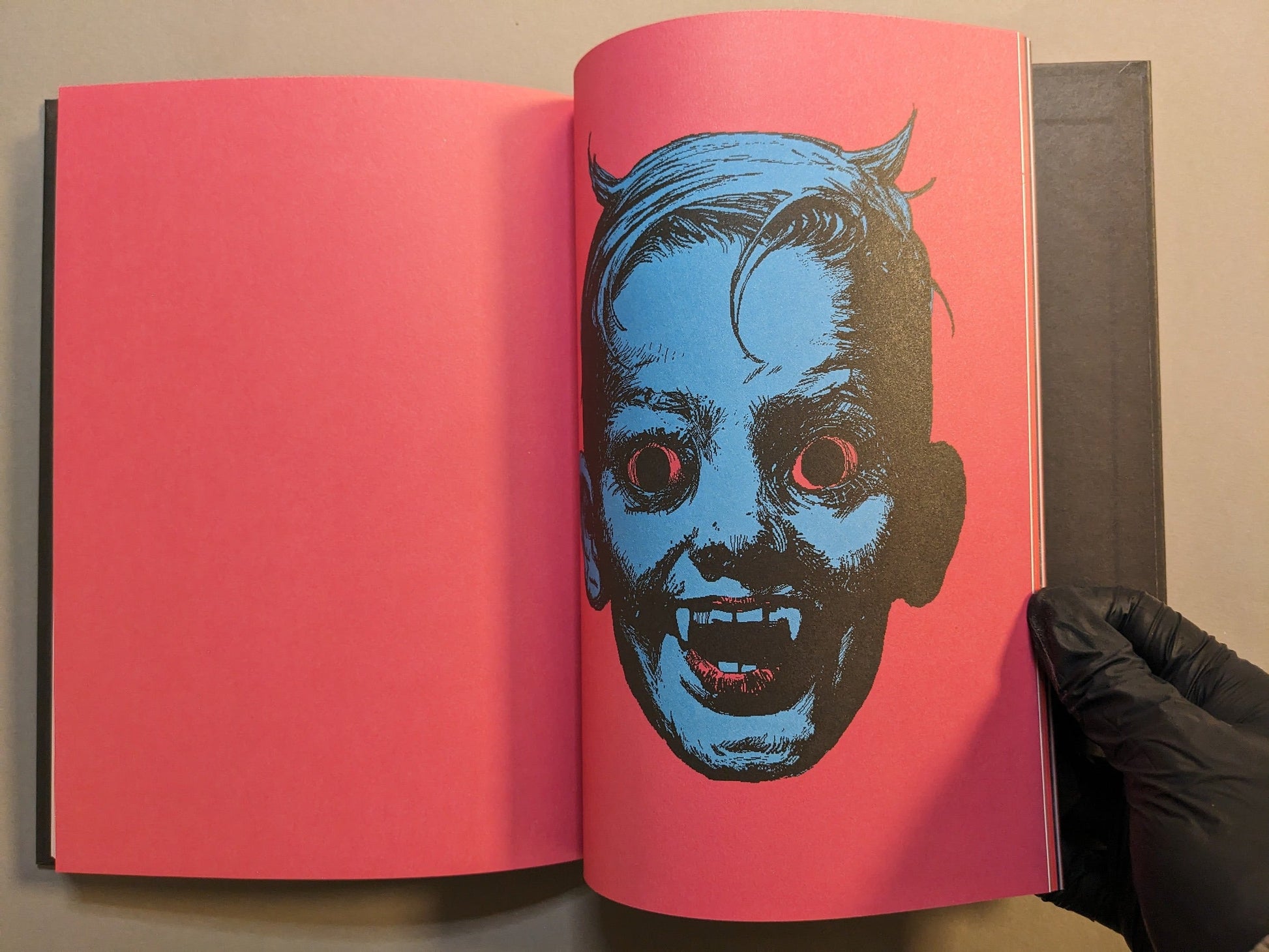 Interior spread with a skeletal jester opposite a horned portrait in ink.