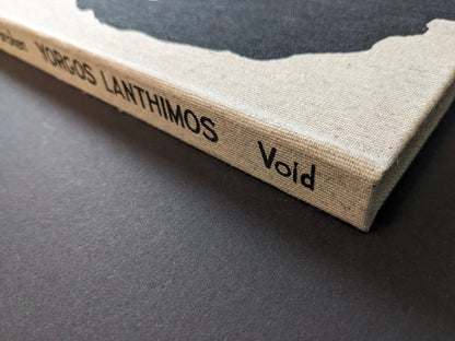 Linen book spine with black titling “Yorgos Lanthimos” and publisher mark “Void”; open-spine binding detail.