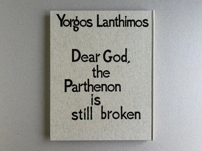 Back cover of Dear God, the Parthenon is still broken by Yorgos Lanthimos, showing the title on a cloth hardcover.