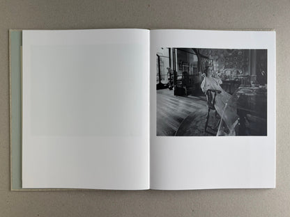 Open spread with a black and white scene on the right and a blank left page in Dear God, the Parthenon is still broken.