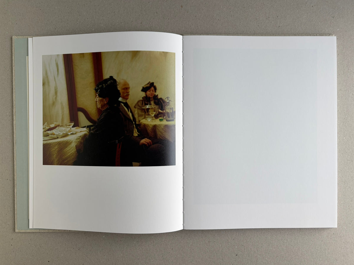 Open spread with a colour scene on the left page and a blank right page in Dear God, the Parthenon is still broken.