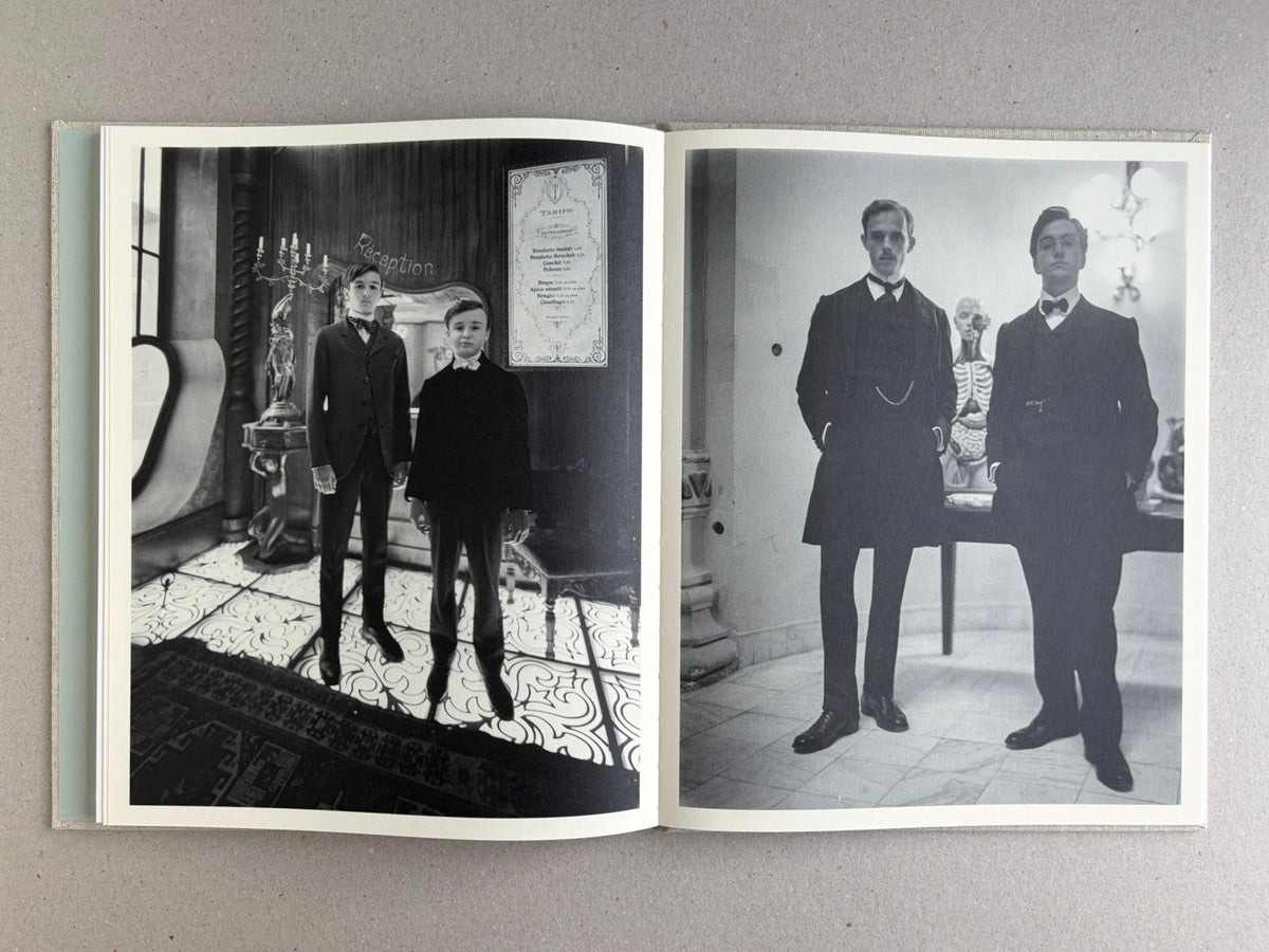 Black-and-white spread with two boys in formal dress on the left and two men in formal dress on the right in Dear God, the Parthenon is still broken.