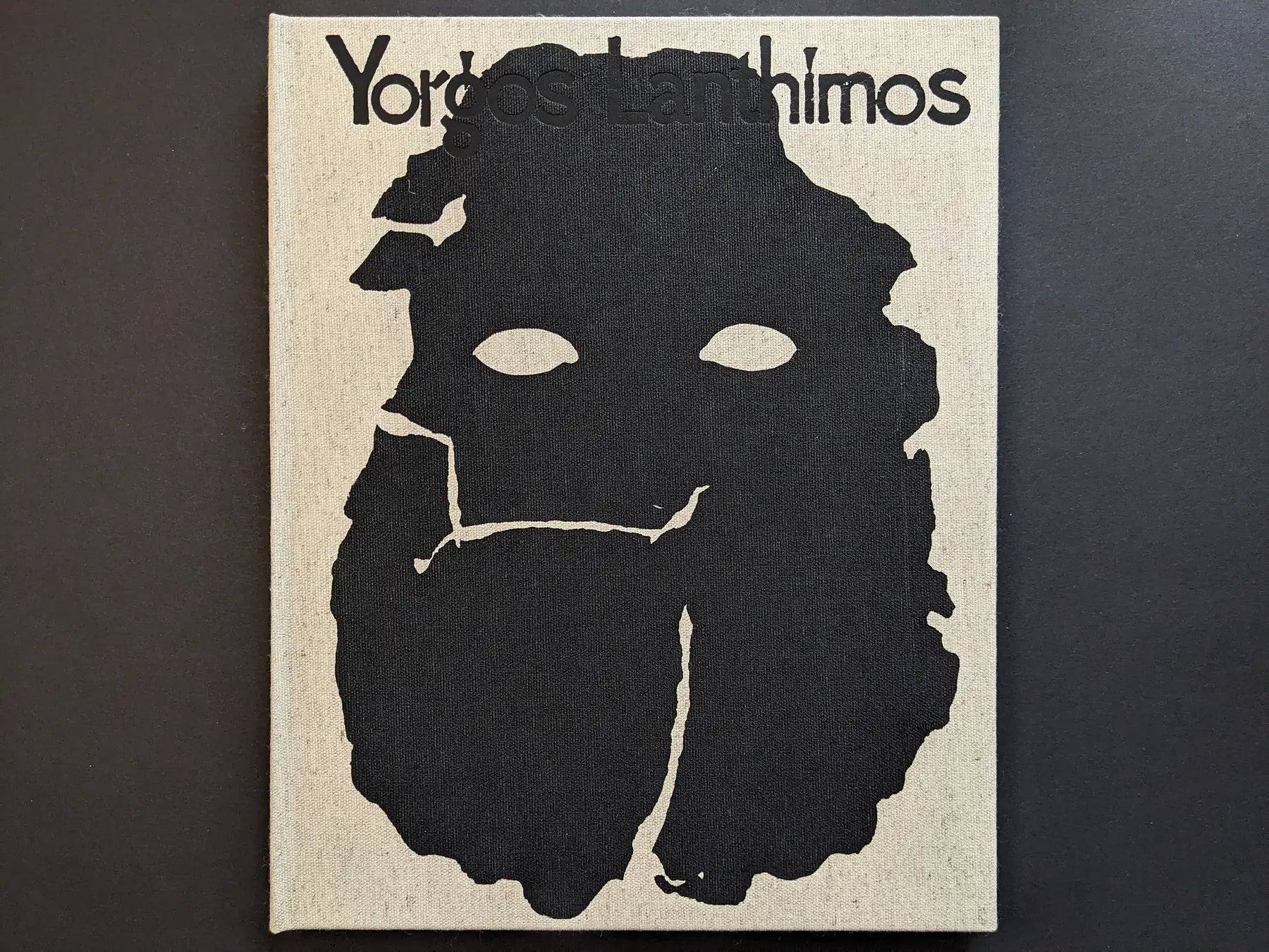 Front cover of Dear God, the Parthenon is still broken by Yorgos Lanthimos on linen cloth.