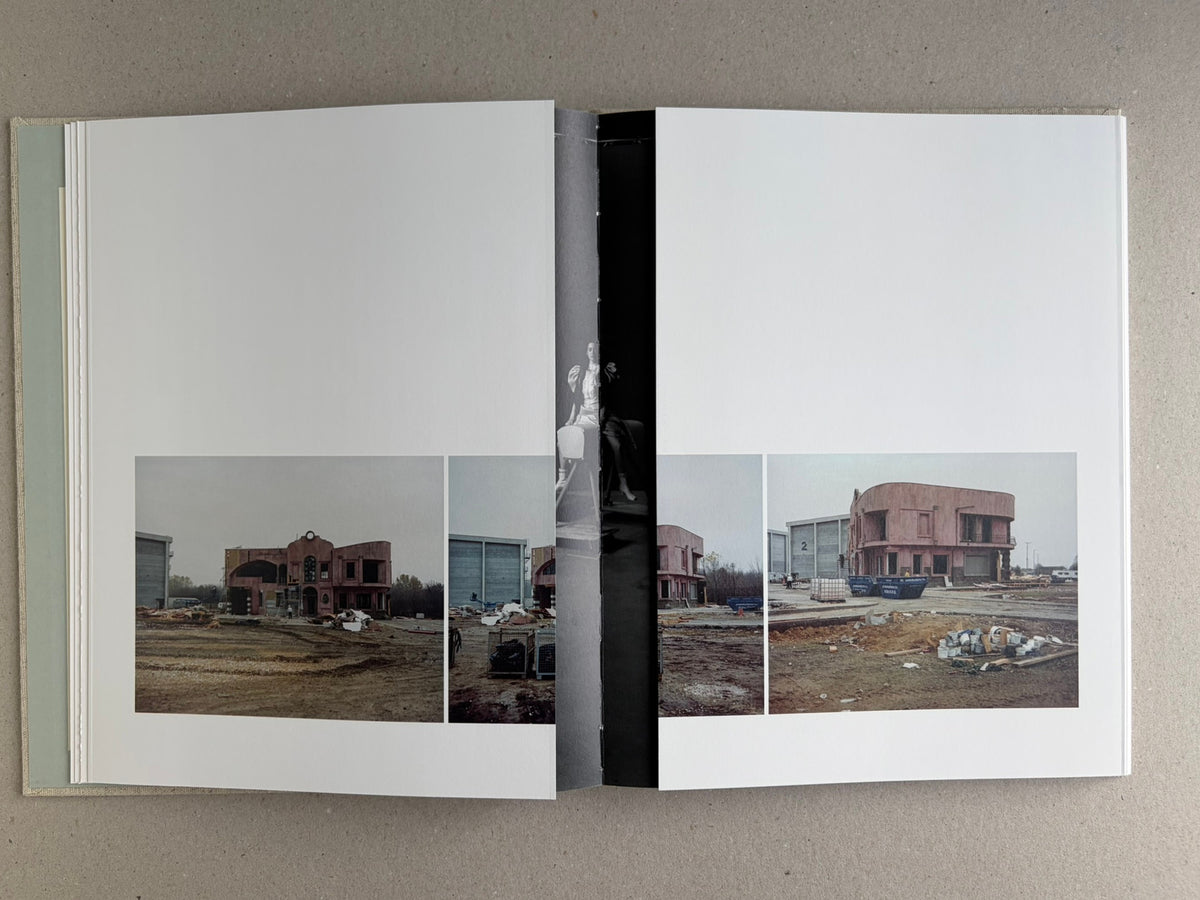Gatefold spread in Dear God, the Parthenon is still broken, showing a panoramic city view across the pages with a narrow central strip.