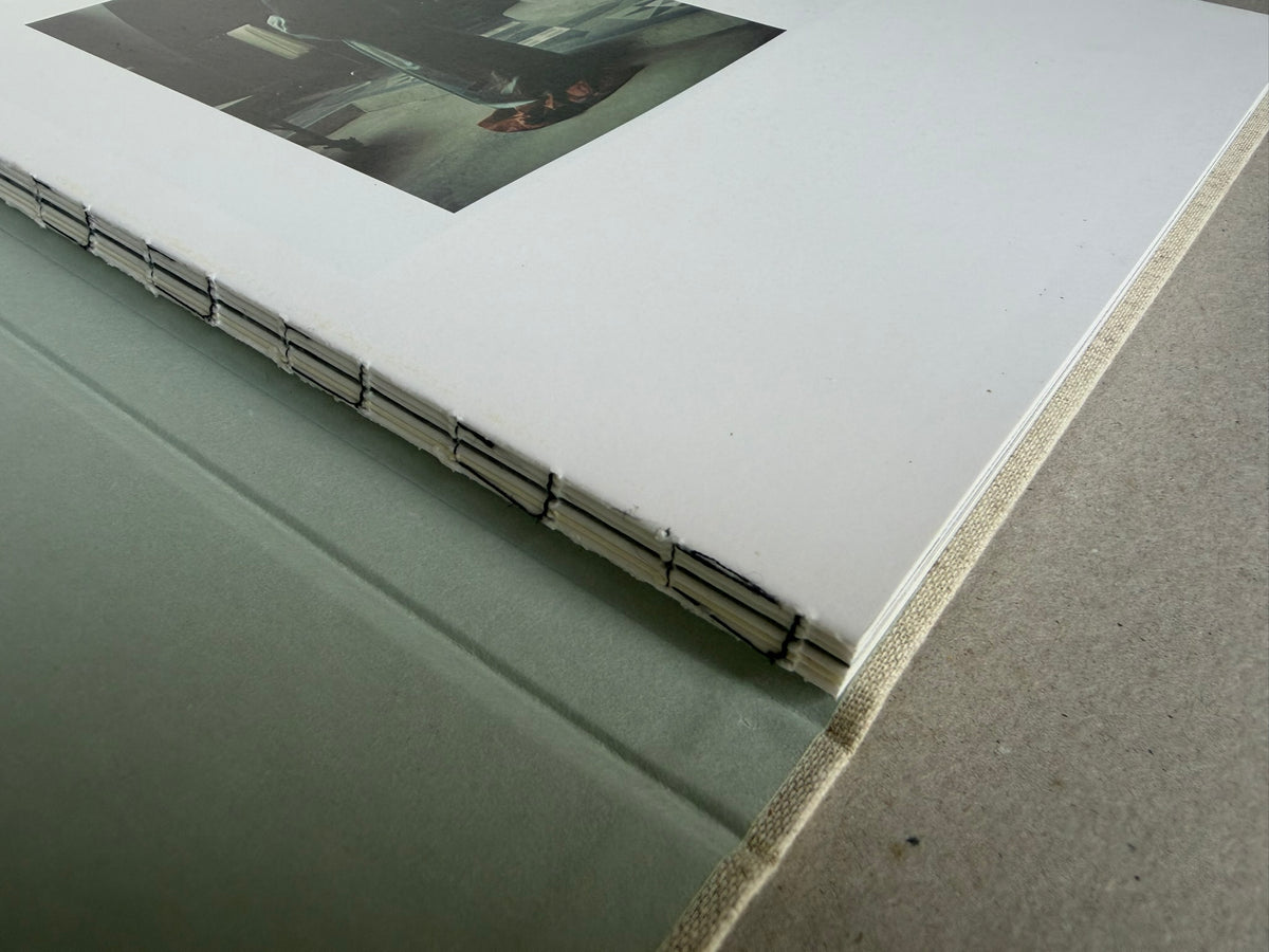 Close view of the binding of Dear God, the Parthenon is still broken by Yorgos Lanthimos, with the title and Void printed in black.