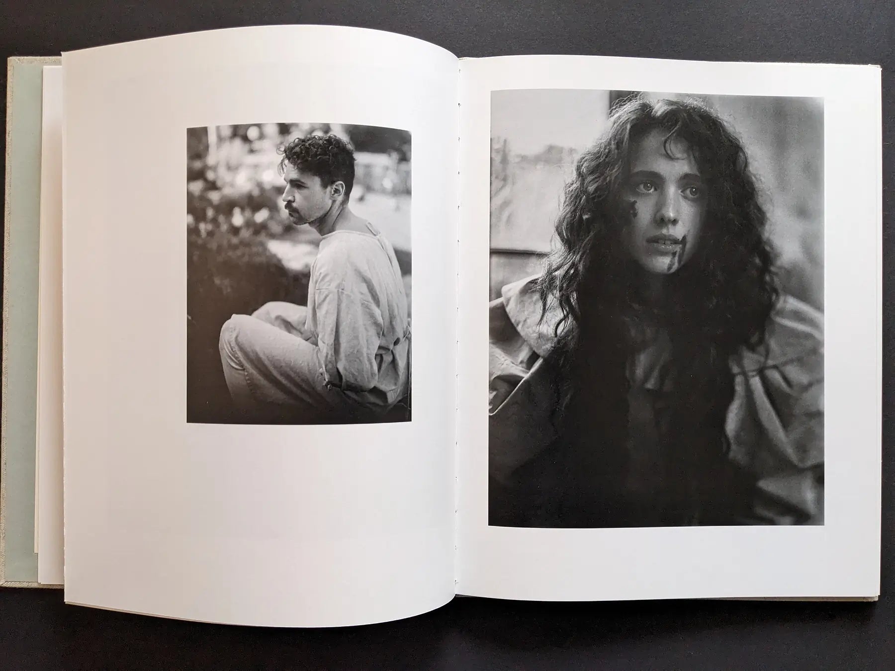 Spread with two portraits—a male profile and a woman with blood on her face—black and white.