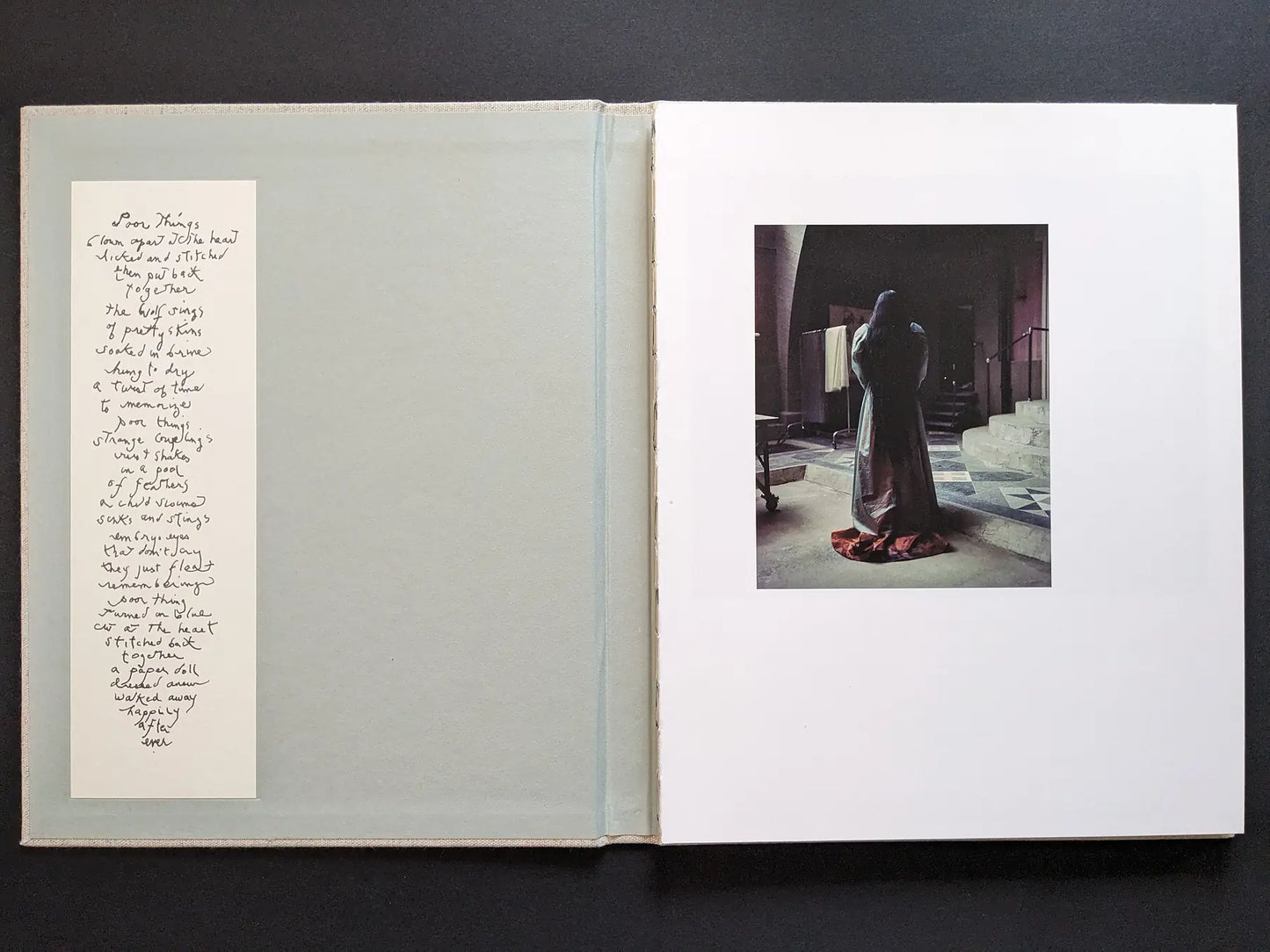 Spread with poem insert and a robed figure on set; cinematic interior from the photobook.