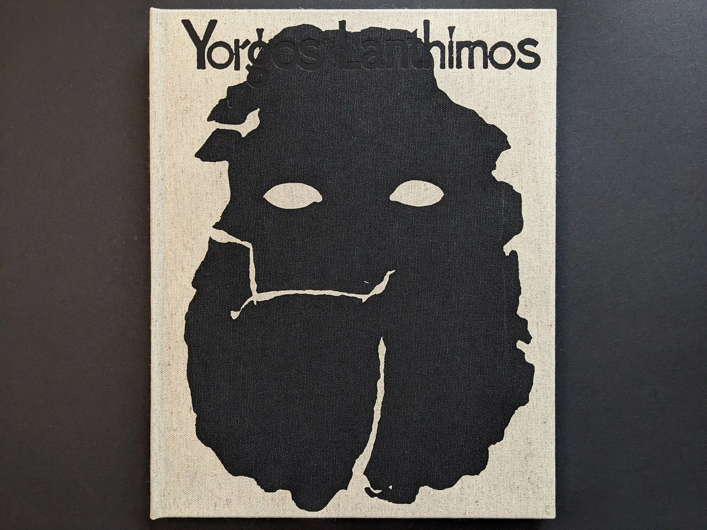 Front cover title on linen cloth for “Dear God, the Parthenon is still broken” by Yorgos Lanthimos, Void.