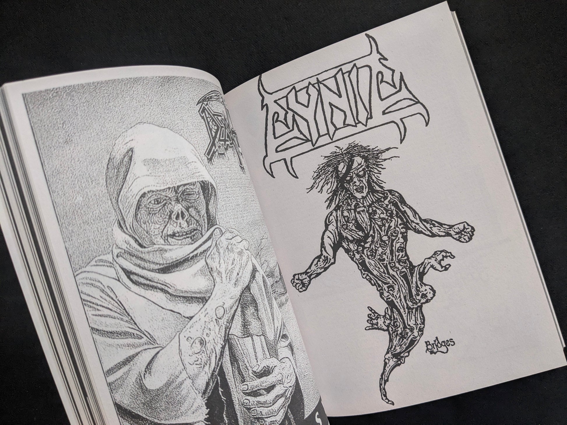 Interior spread with a hooded figure illustration and bold underground lettering.