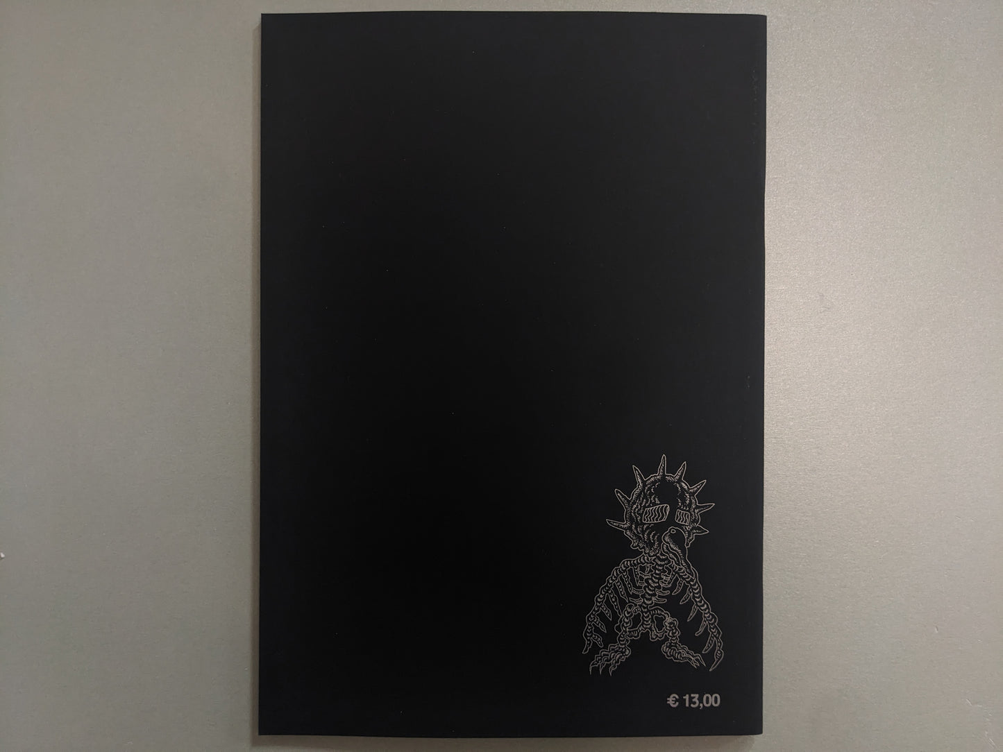 Back cover of Dimensional Flats on black ground, with a skeletal mutant and printed price.
