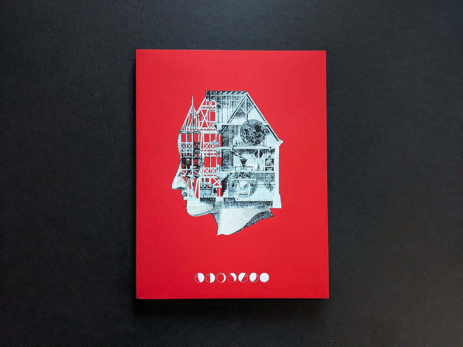 Front cover of Dream Moons by Yurian Quintanas Nobel, red cover with a collage profile head and moon-phase symbols.