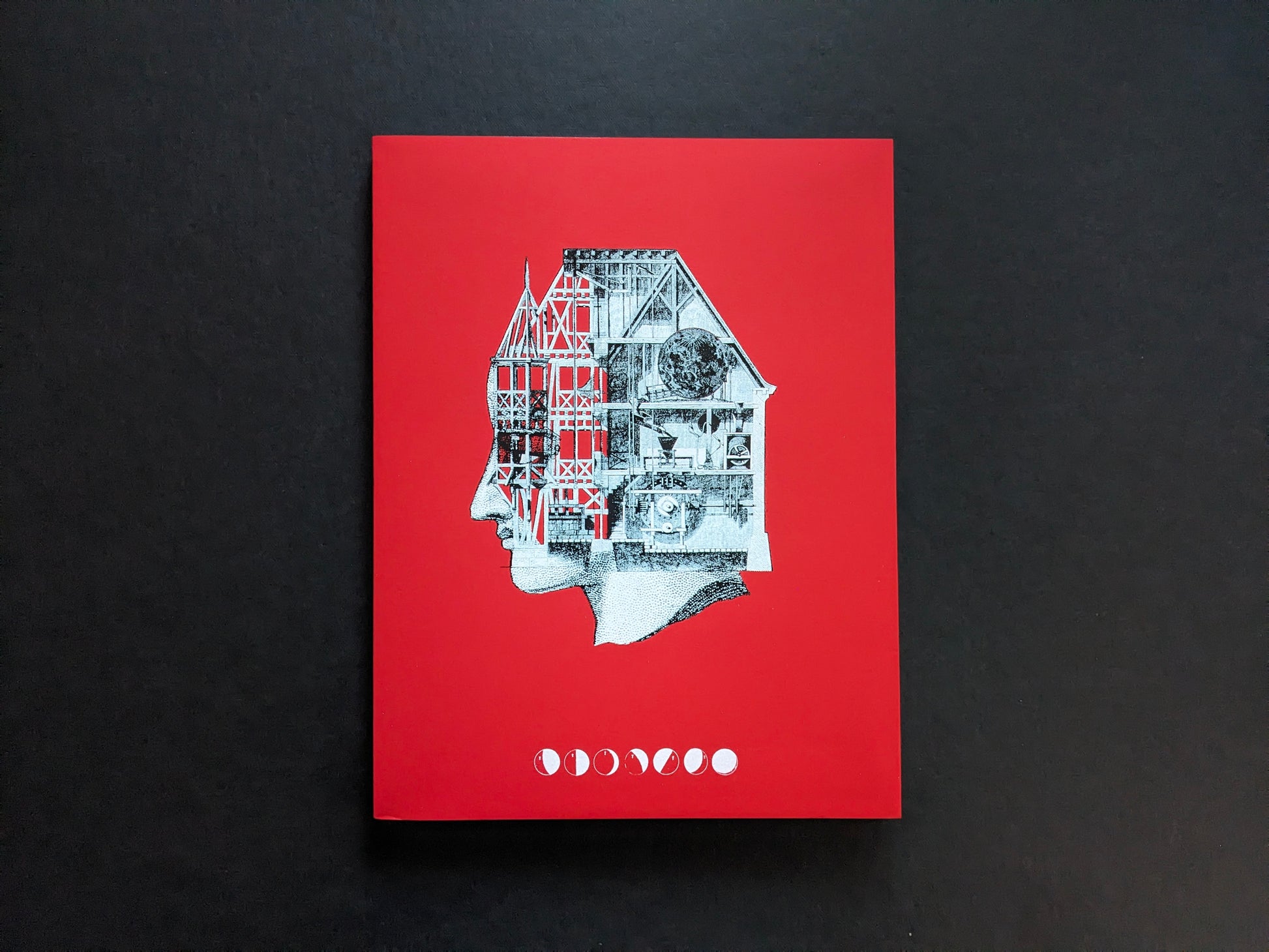 Front cover of Dream Moons by Yurian Quintanas Nobel, red cover with a collage profile head and moon-phase symbols.
