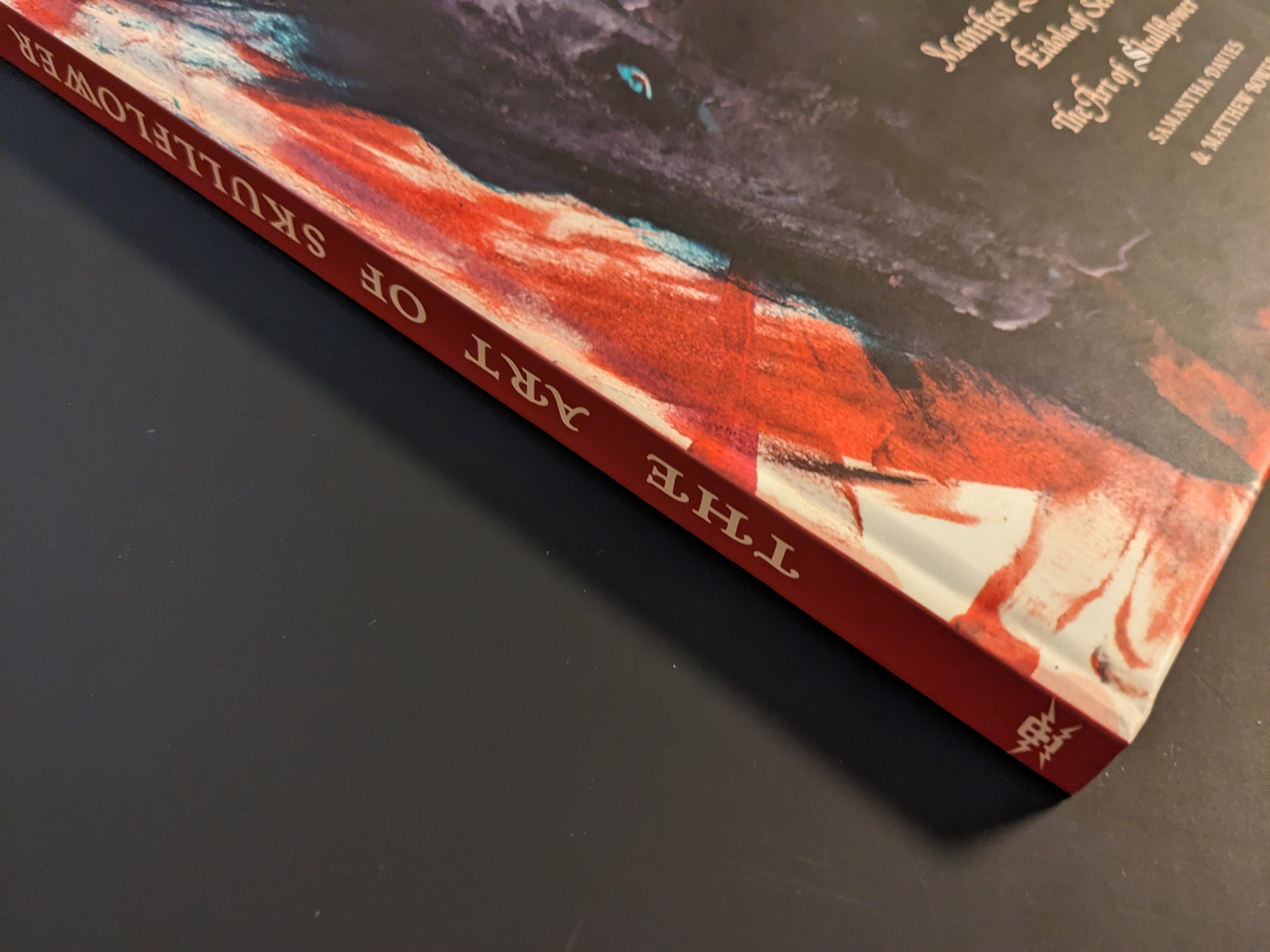 Book spine of "Eidola of Set – The Art of Skullflower" showing title and publisher’s logo