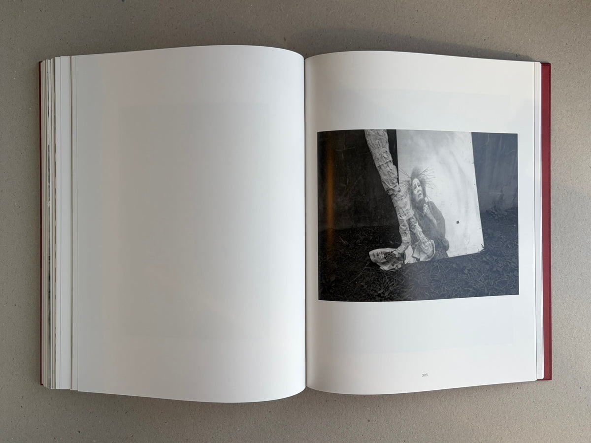 Open spread from Eikoh Hosoe showing a black-and-white photograph on the right-hand page, with page number 305 visible.