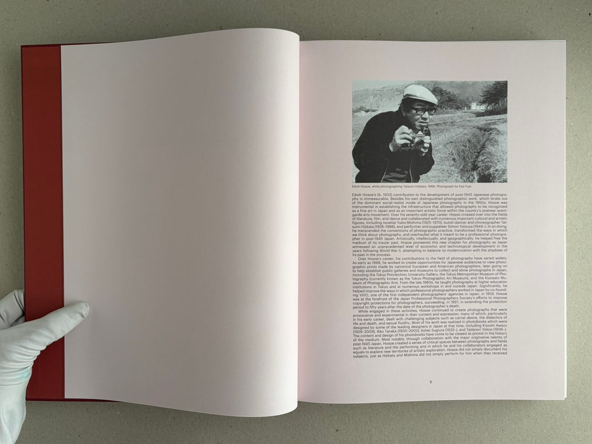 Open spread of Eikoh Hosoe, English edition, showing a page with a black-and-white portrait and text on the right and a blank left page with a red inner cover visible at the spine.