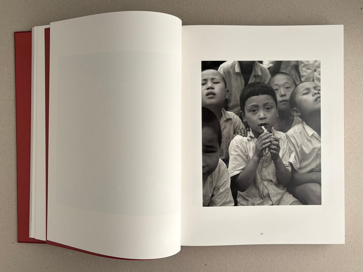 Open spread of Eikoh Hosoe, English edition, showing a black-and-white photograph of children on the right-hand page.