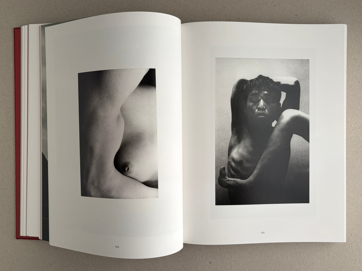 Open spread from Eikoh Hosoe, English edition: two black-and-white photographs on pages 104–105, including a close crop of a torso and a seated nude figure.