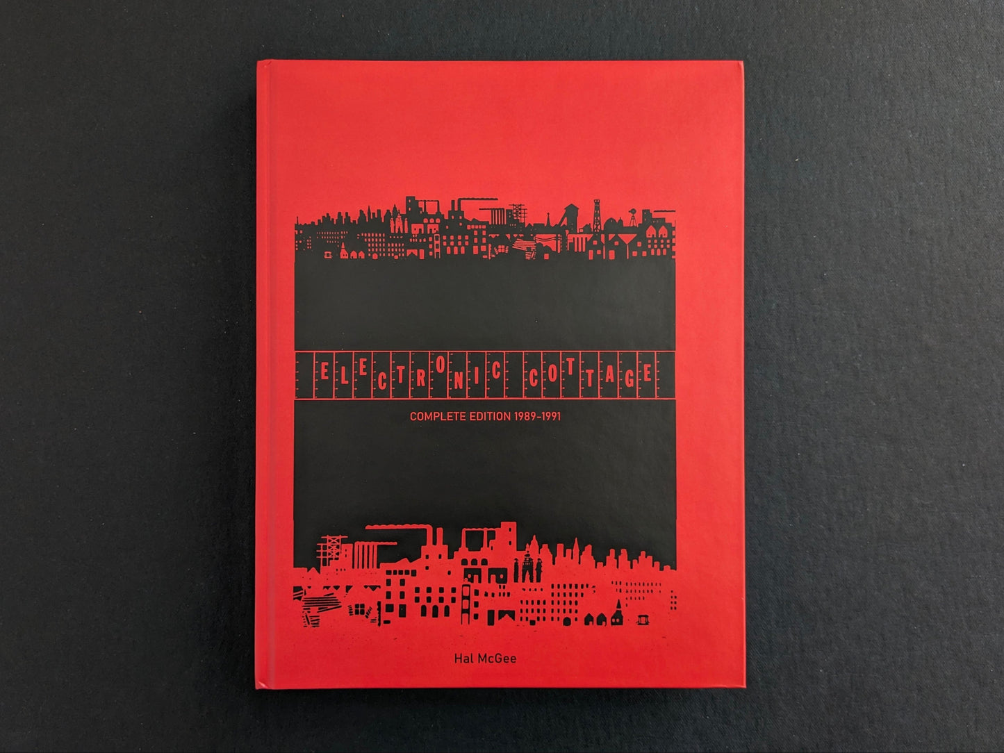 Front cover of Electronic Cottage by Hal McGee, a red hardcover with a black central panel and skyline graphic.
