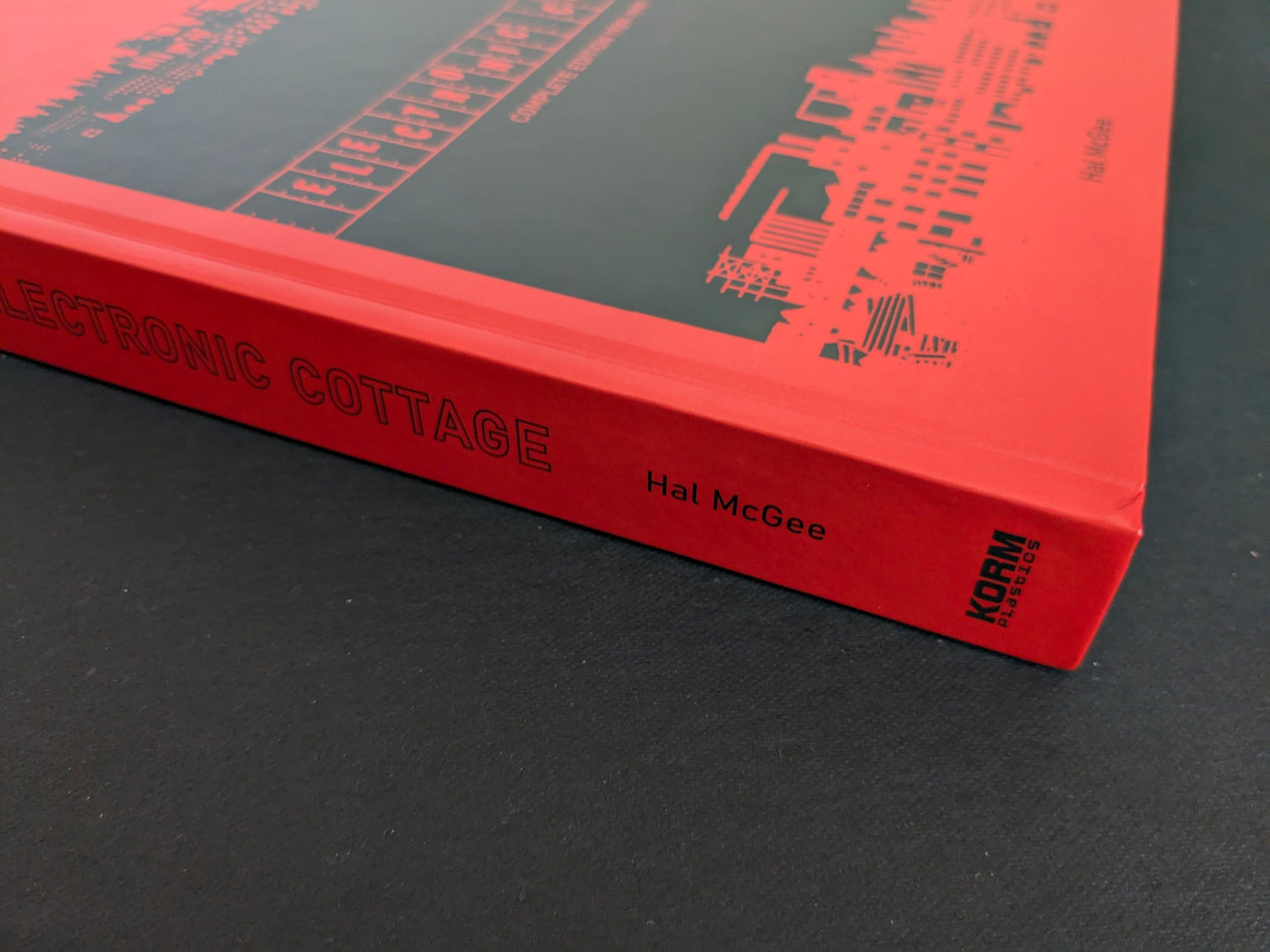 Spine of Electronic Cottage by Hal McGee, showing the title and Korm Plastics logo on a red hardcover.