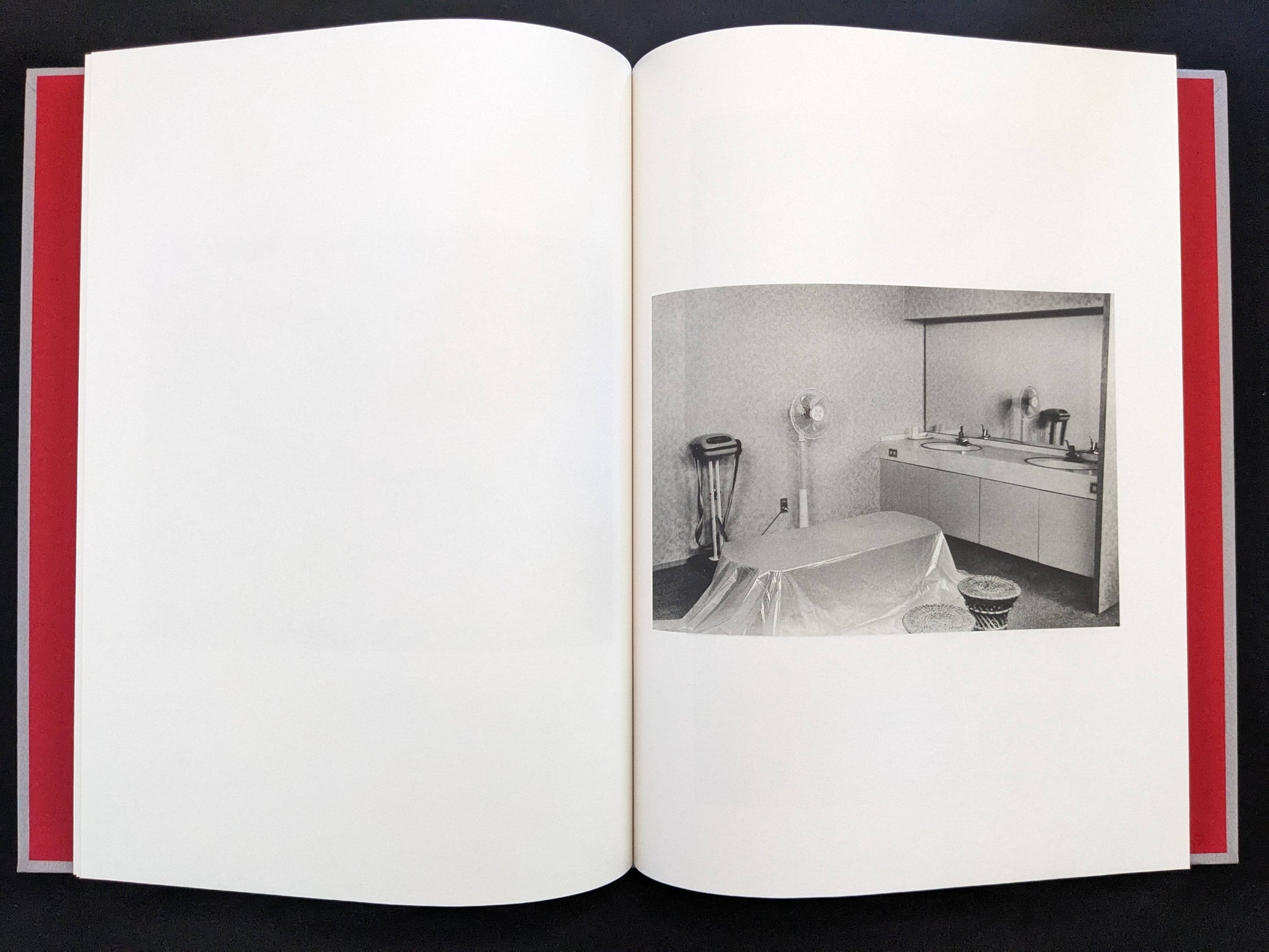 Open spread with a black-and-white interior photograph on the right page in Eros Lost.