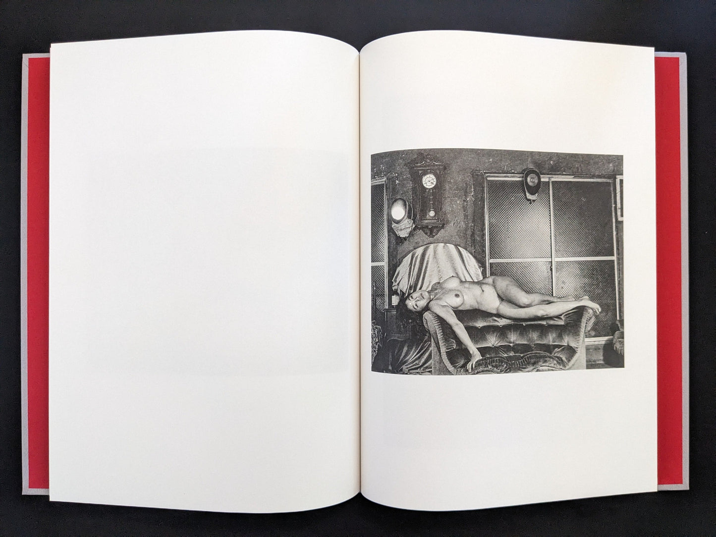 Open spread with a black-and-white nude figure reclining on a bed in Eros Lost.